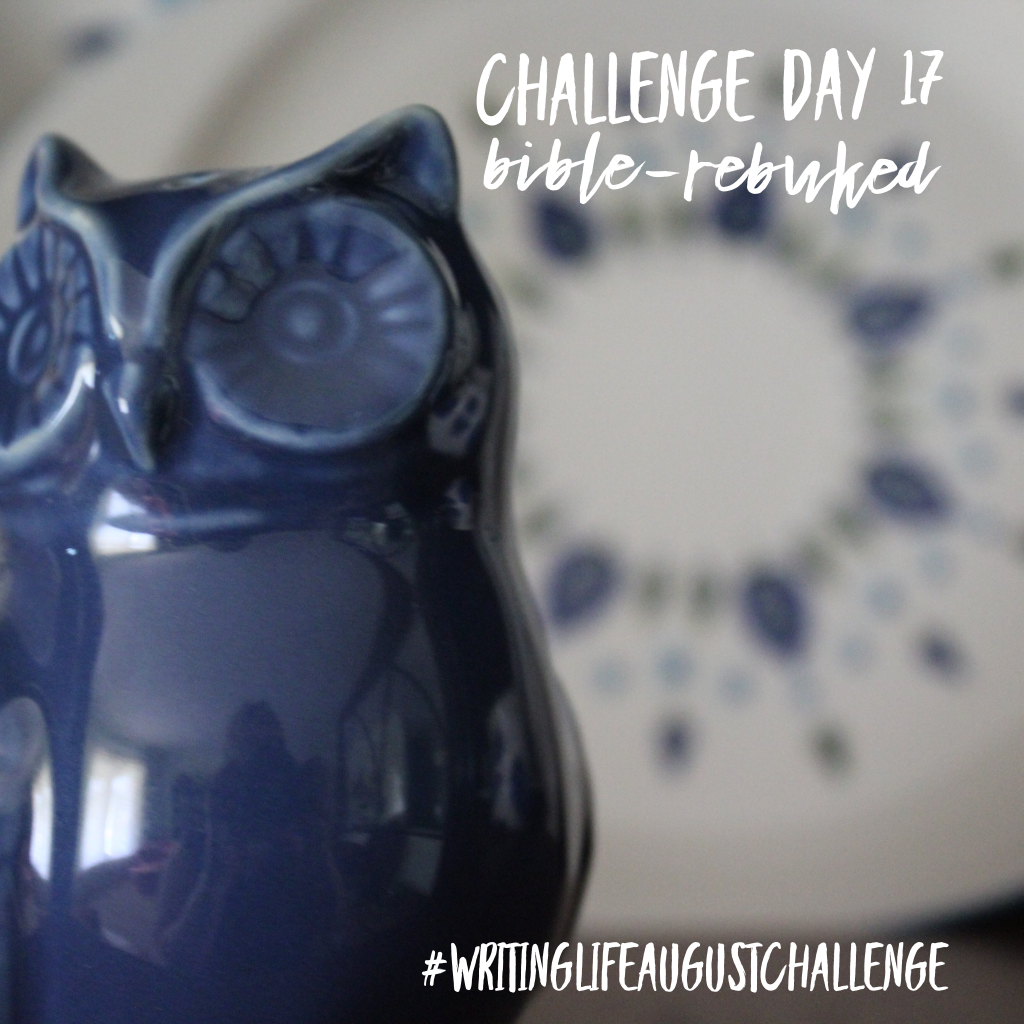 Blue ceramic owl salt (or pepper) shaker sitting in front of an antique cream and blue dish set. Photo text: Challenge Day 16, Bible-rebuked. #writinglifeaugustchallenge