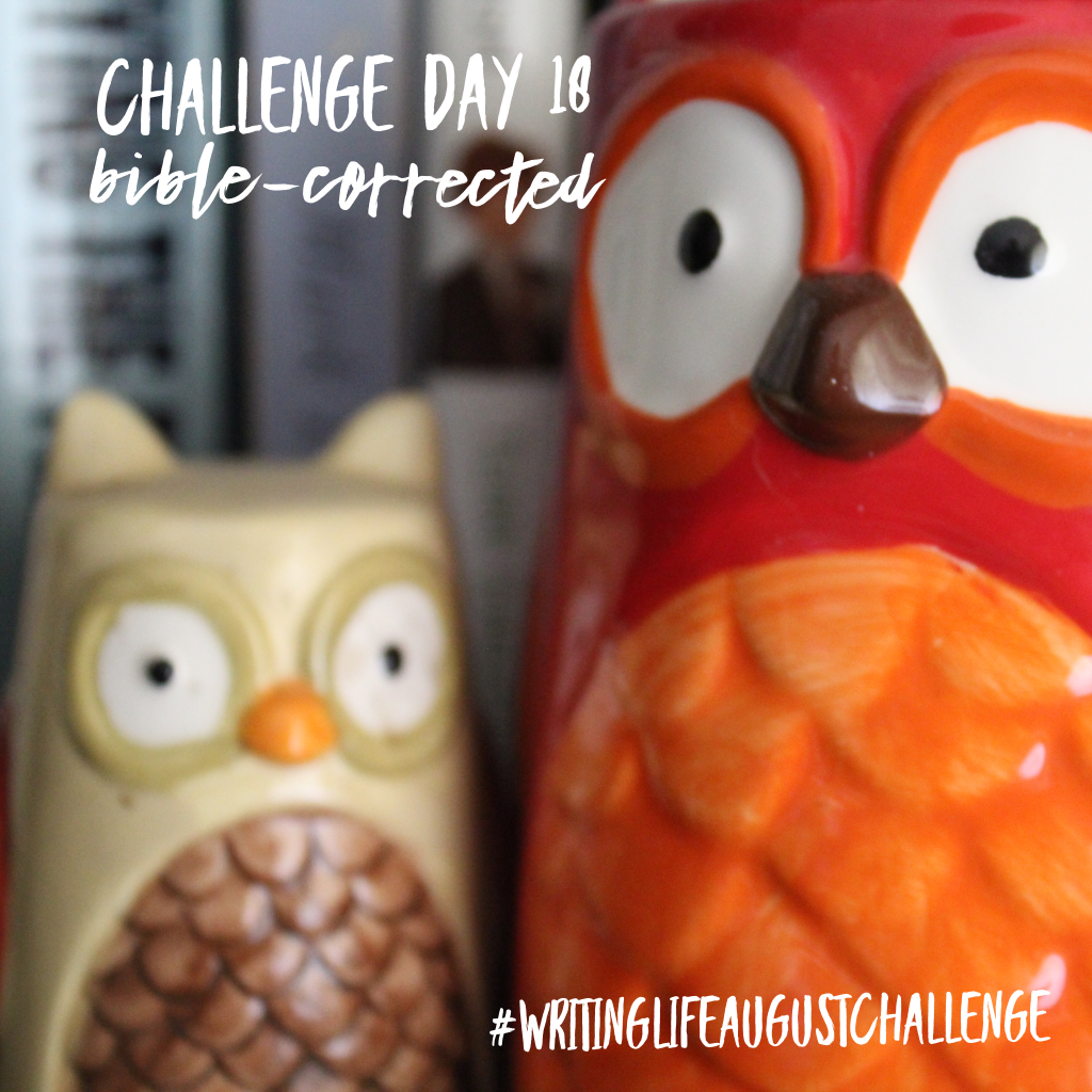 Beige owl salt/pepper shaker sitting next to a red and orange owl mug on a bookshelf. Photo text: Challenge Day 18, Bible-corrected. #writinglifeaugustchallenge